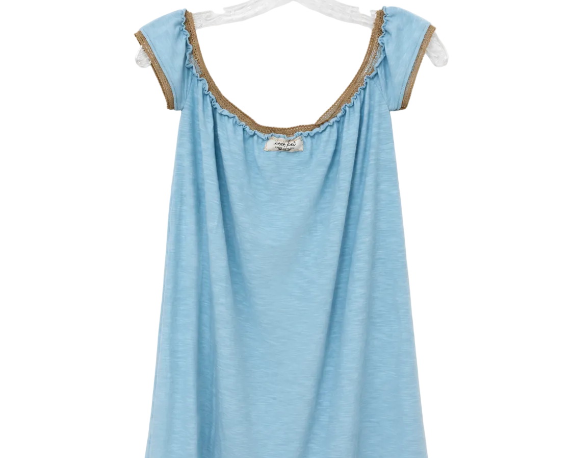 A light blue sleeveless top with ruffled trim and lace-up shoulder details, hanging on a clear plastic hanger against a white background.