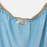 Close-up of a light blue top with a ruffled neckline trimmed in beige lace, featuring a visible 'sophia fair' brand label.