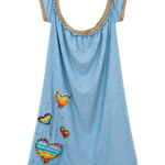 A light blue sleeveless tunic dress with a scoop neckline trimmed in tan lace, decorated with colorful striped fabric hearts and small silver rhinestones, shown against a plain white background.