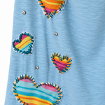 A close-up of a light blue heathered fabric garment featuring three colorful striped fabric hearts with frayed edges and small silver rhinestone embellishments.