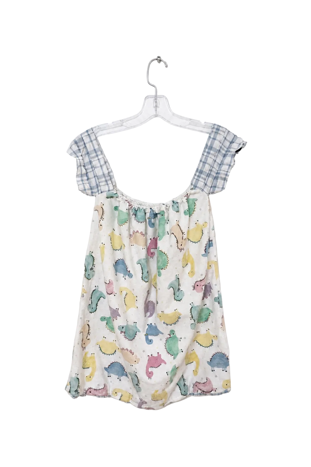 A baby romper hanging on a clear plastic hanger against a white wall. The romper features a cream-colored body with a colorful dinosaur print in shades of blue, green, yellow, and pink, and has light blue and white gingham checkered shoulder straps.