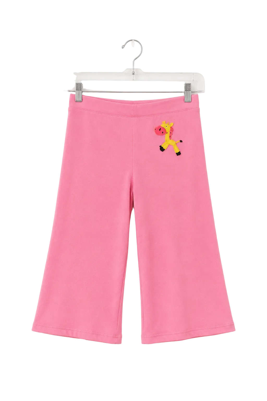 Pink wide-leg cropped pants for kids, hanging on a clear plastic hanger against a white background. The pants feature a small embroidered giraffe motif on the upper left hip.