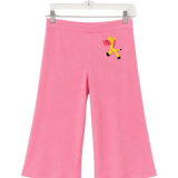 Pink wide-leg cropped pants for kids, hanging on a clear plastic hanger against a white background. The pants feature a small embroidered giraffe motif on the upper left hip.