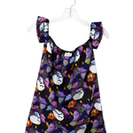 A sleeveless babydoll dress with a dark purple and black background, featuring a playful print of cartoon cats in white, purple, orange, and yellow. The dress has ruffled shoulder straps and is displayed on a clear plastic hanger against a plain white background.