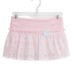 A light pink eyelet lace skirt with a ruffled waistband and a single light blue decorative button, hanging on a clear plastic hanger against a plain white background.
