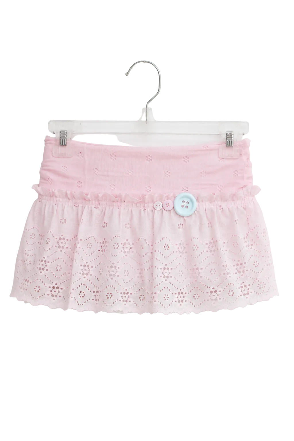 A light pink eyelet lace skirt with a ruffled waistband and a single light blue decorative button, hanging on a clear plastic hanger against a plain white background.
