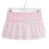A light pink eyelet lace skirt with a ruffled waistband and a single light blue decorative button, hanging on a clear plastic hanger against a plain white background.