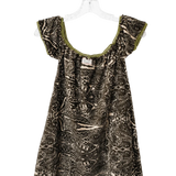 A short-sleeve babydoll dress with an abstract black and beige pattern, featuring olive green trim along the scoop neckline, hanging on a clear plastic hanger against a white background.