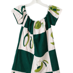 A short-sleeve dress with a green and white checkered pattern and olive illustrations, hanging on a white plastic hanger against a plain white wall.