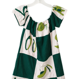 A short-sleeve dress with a green and white checkered pattern and olive illustrations, hanging on a white plastic hanger against a plain white wall.
