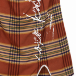 Rust Plaid Mini Dress - close up of front slit and lace trim detail