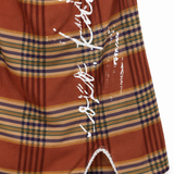 Rust Plaid Mini Dress - close up of front slit and lace trim detail