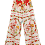 A pair of 1983 wide-leg cropped pants featuring a colorful Strawberry Shortcake-themed print with red strawberries, cartoon characters, and text on a cream background.