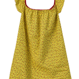 A yellow off-the-shoulder dress with a small red and green floral pattern, featuring a red inner trim and a white lace hem, shown against a plain white background.