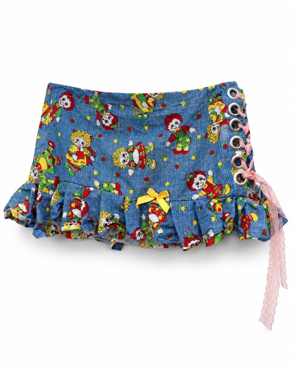 The Rag Doll Ruffle Mini - front view showing yellow bow and pink lace-up side detail