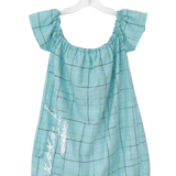 A light blue-green plaid baby dress with ruffled off-the-shoulder sleeves and white script embroidery on the front, hanging on a clear plastic hanger against a white background.